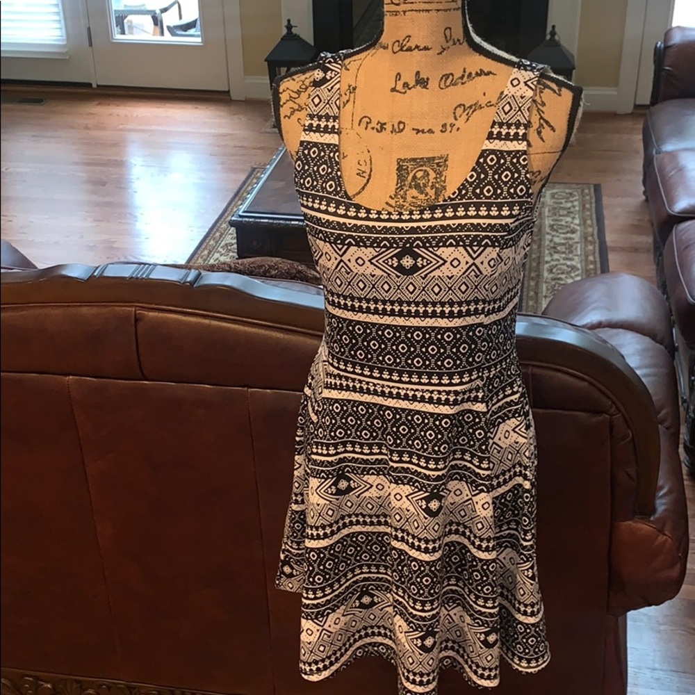 Black and white pleated sleeveless mini dress.